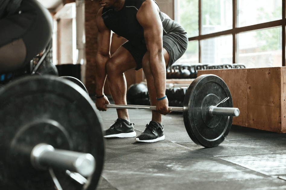 Cropped image of a young african sportsman lifting a barbell at the gym